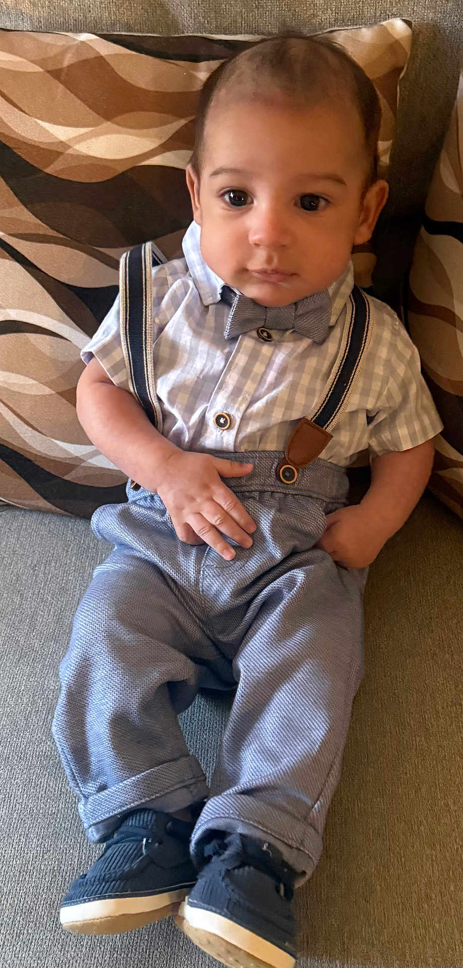 Rj joined the competition — help win amazing prizes! baby, infant, child, bow_tie, suspenders, shirt, pants, shoes, couch, pillow, patterned_pillow, sitting, portrait, hands, eyes, face, cute, formal_outfit, indoor, cozy