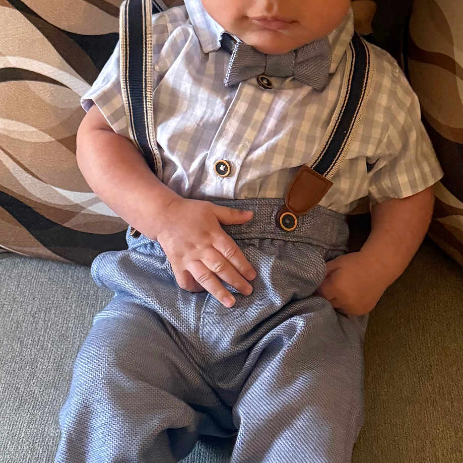 Ralph Jace Valentin is registered to the contest to win money with this photo: baby, bow_tie, child, couch, cozy, cute, eyes, face, formal_outfit, hands, indoor, infant, pants, patterned_pillow, pillow, portrait, shirt, shoes, sitting, suspenders