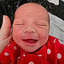 newborn, baby, smiling, red_clothing, polka_dot, face, hand, sleeping, infant, close_up, cute, cozy, blanket, portrait, child, happy, apparel, skin, head, expression