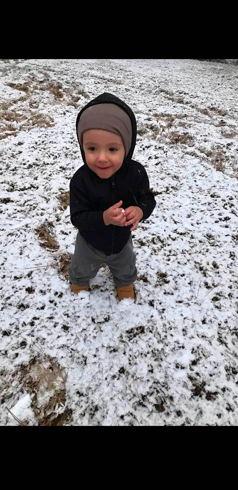 Jordan is registered to the contest to win money with this photo: baby, baby_toddler_clothing, beanie, cap, child, freezing, fun, grass, headwear, hoodie, joy, landscape, people_in_nature, person, play, playing_in_the_snow, precipitation, recreation, smile, snow
