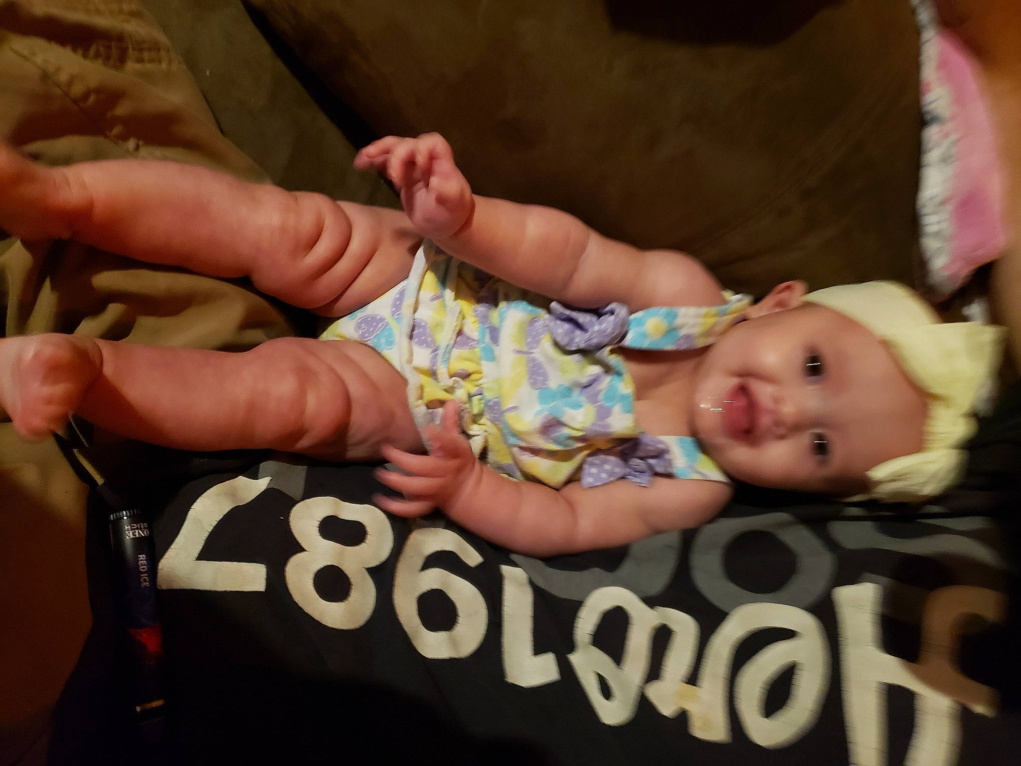 Mia is registered to the contest to win money with this photo: baby, baby_carriage, baby_products, baby_toddler_clothing, cheek, child, comfort, eye, finger, fun, happy, head, headwear, mammal, nail, person, product, sitting, skin, thumb