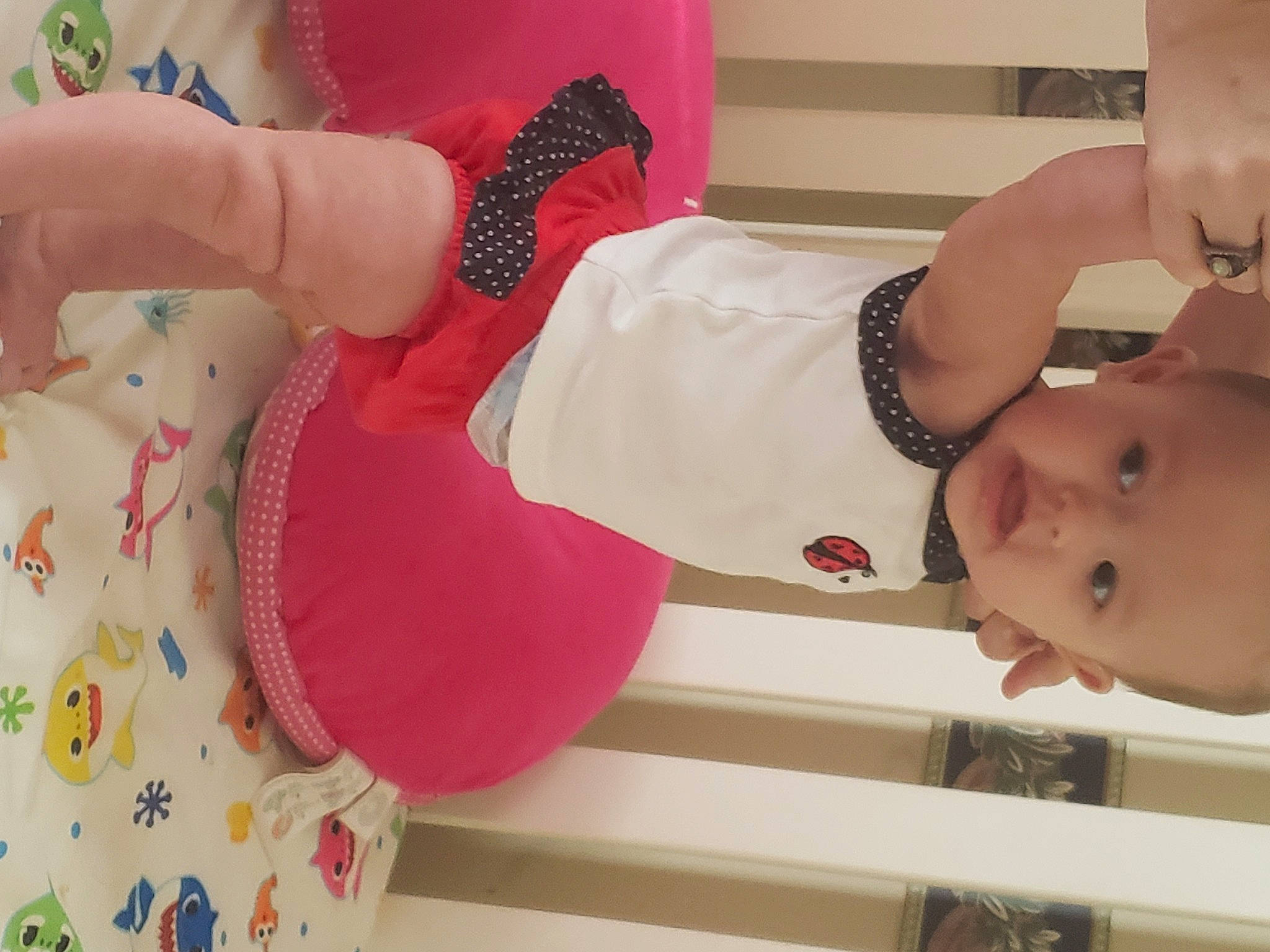Mia is registered to the contest to win money with this photo: arm, baby_toddler_clothing, chest, child, finger, hand, headgear, human_body, human_leg, knee, leg, nail, neck, organ, person, pink, sleeve, textile, thigh, toddler