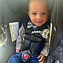 toddler, child, car_seat, safety_harness, bow_tie, blue_vest, smile, cute, baby, polka_dot_shirt, face, hands, indoors, seatbelt, child_safety, happy, young_child, portrait, infant, clothing