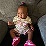 baby, girl, smile, sitting, couch, clothing, shoes, pink, watermelon, happy, jewelry, hair_accessory, infant, cute, portrait, indoor, child, footwear, toddler, fashion