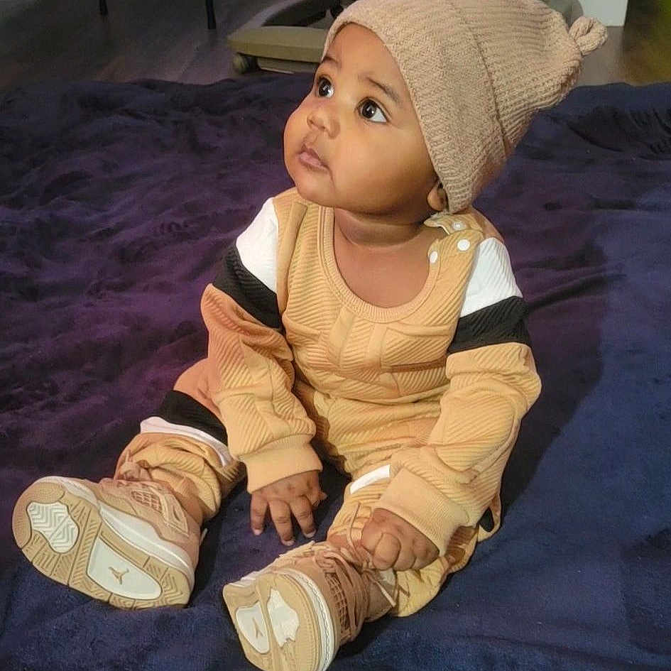 Yohan joined the competition — help win amazing prizes! baby, beanie_hat, big_eyes, blanket, brown_clothing, carpet, child, cozy, cute, face, floor, hands, indoor, infant, looking_up, onesie, portrait, sitting, sneakers, toddler