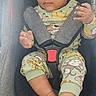 baby, child, car_seat, pajamas, animal_print, safety_harness, infant, cute, indoors, seat, footwearless, looking_away, clothing, young_child, seatbelt, portrait, person, toddler, hands, feet