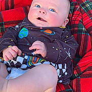 Tucker is registered to the contest to win money with this photo: baby, blanket, clothing, coat, cushion, diaper, face, furniture, head, homedecor, jacket, newborn, pants, person, photography, portrait, quilt, shorts, sleeping, tartan