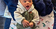 Luca joined the competition — help win amazing prizes! baby, blanket, child, clothing, cozy, cute, expression, flooring, footprint_pattern, indoor, infant, laying, pants, person, sherpa_jacket, socks, surprised, texture, towel, warm