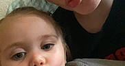 Leilani joined the competition — help win amazing prizes! casual_clothing, child, close_up, cute, face, fun, hair, holding_object, indoor, mickey_mouse, person, playful, portrait, puckered_lips, seated, selfie, skin, sweatshirt, toddler, woman