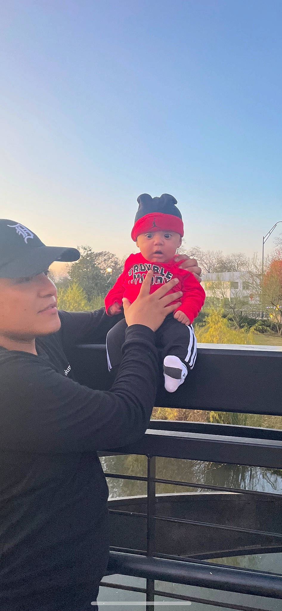 Ezekiel is registered to the contest to win money with this photo: baseball_cap, cap, cool, face, flash_photography, fun, gesture, grass, happy, hat, headgear, headwear, leisure, mountainous_landforms, person, plant, recreation, sky, toddler, travel