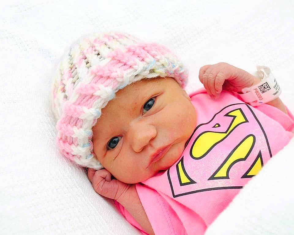 Lilly-ann is registered to the contest to win money with this photo: baby, beanie, bonnet, cap, cheek, child, clothing, ear, fashion_accessory, hat, head, headgear, headwear, knit_cap, outerwear, person, pink, product, smile, toddler