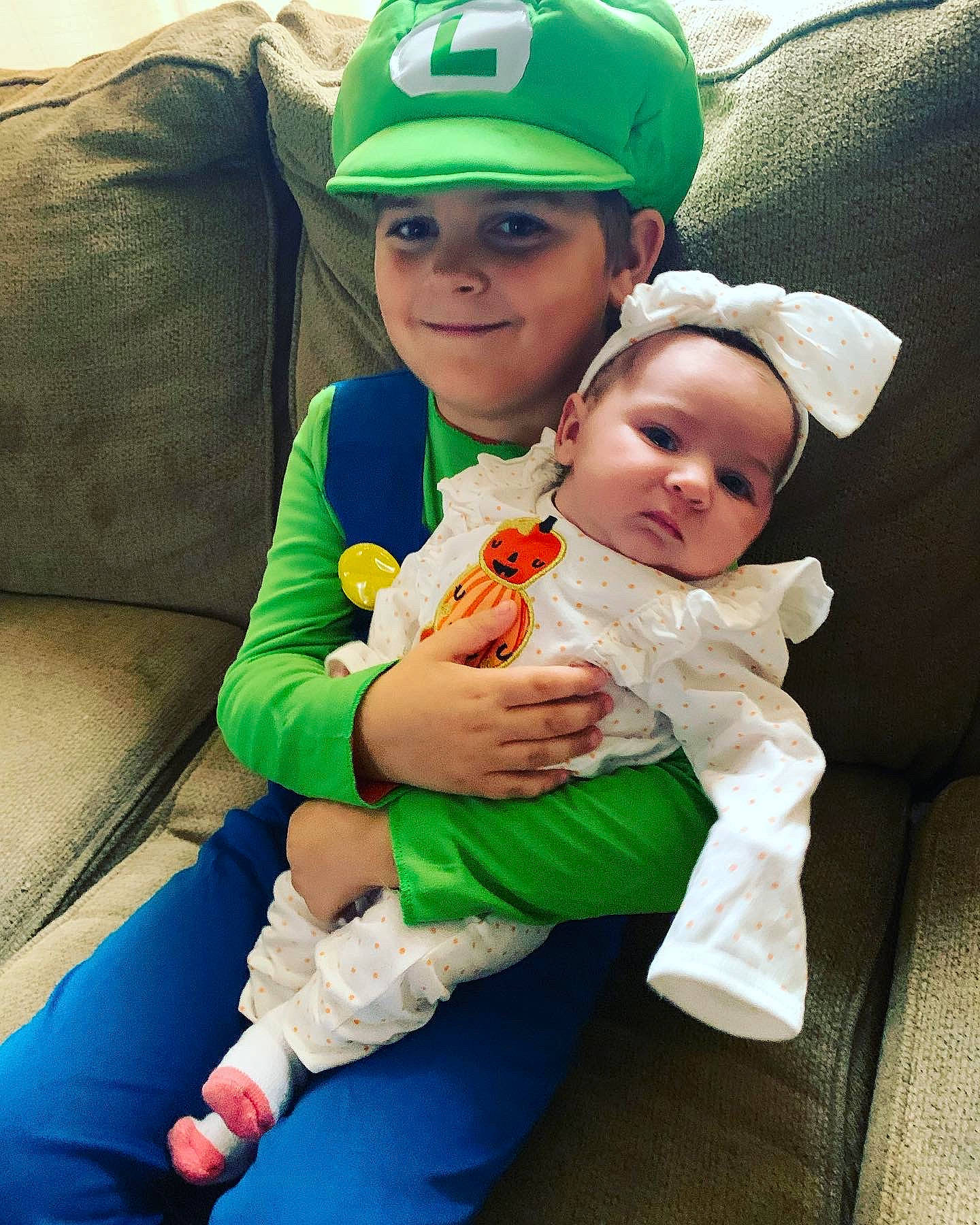 Caylee joined the competition — help win amazing prizes! baby, baby_products, baby_toddler_clothing, baseball_cap, cap, child, clothing, comfort, event, fashion_accessory, fun, gesture, grass, green, happy, hat, headwear, joy, lap, person