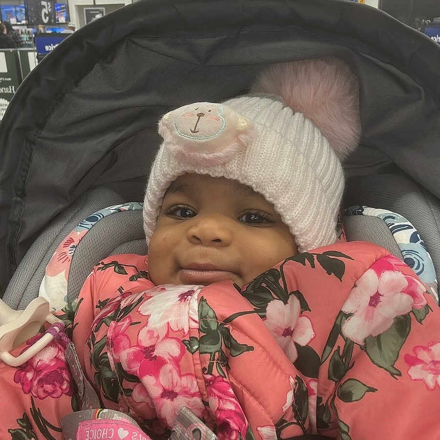 Ariyah is registered to the contest to win money with this photo: architecture, baby, building, cap, clothing, coat, cushion, face, glove, hat, head, homedecor, jacket, outdoors, person, photography, portrait, shelter, sleeping, transportation