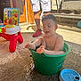 adult, bath, bucket, child, colorful, concrete, fun, green_bucket, happy, home, outdoor, playtime, red_shoes, shoes, shorts, summer, sunlight, toddler, toys, water