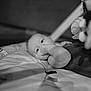 Octavia a rejoint le concours — aidez-le/la à gagner de superbes lots ! baby, infant, thumb_sucking, black_and_white, portrait, close_up, soft_light, quilted_surface, child, face, eyes, hand, sleeping_mat, indoor, cute, young_child, calm, resting, person, monochrome