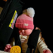 Octavia a rejoint le concours — aidez-le/la à gagner de superbes lots ! baby, black_harness, car_seat, child, chubby_cheeks, closeup, cozy, cute, face, hands, headwear, indoors, infant, peaceful, pink_hat, pom_pom, sleeping, soft_texture, white_clothing, yellow_toy