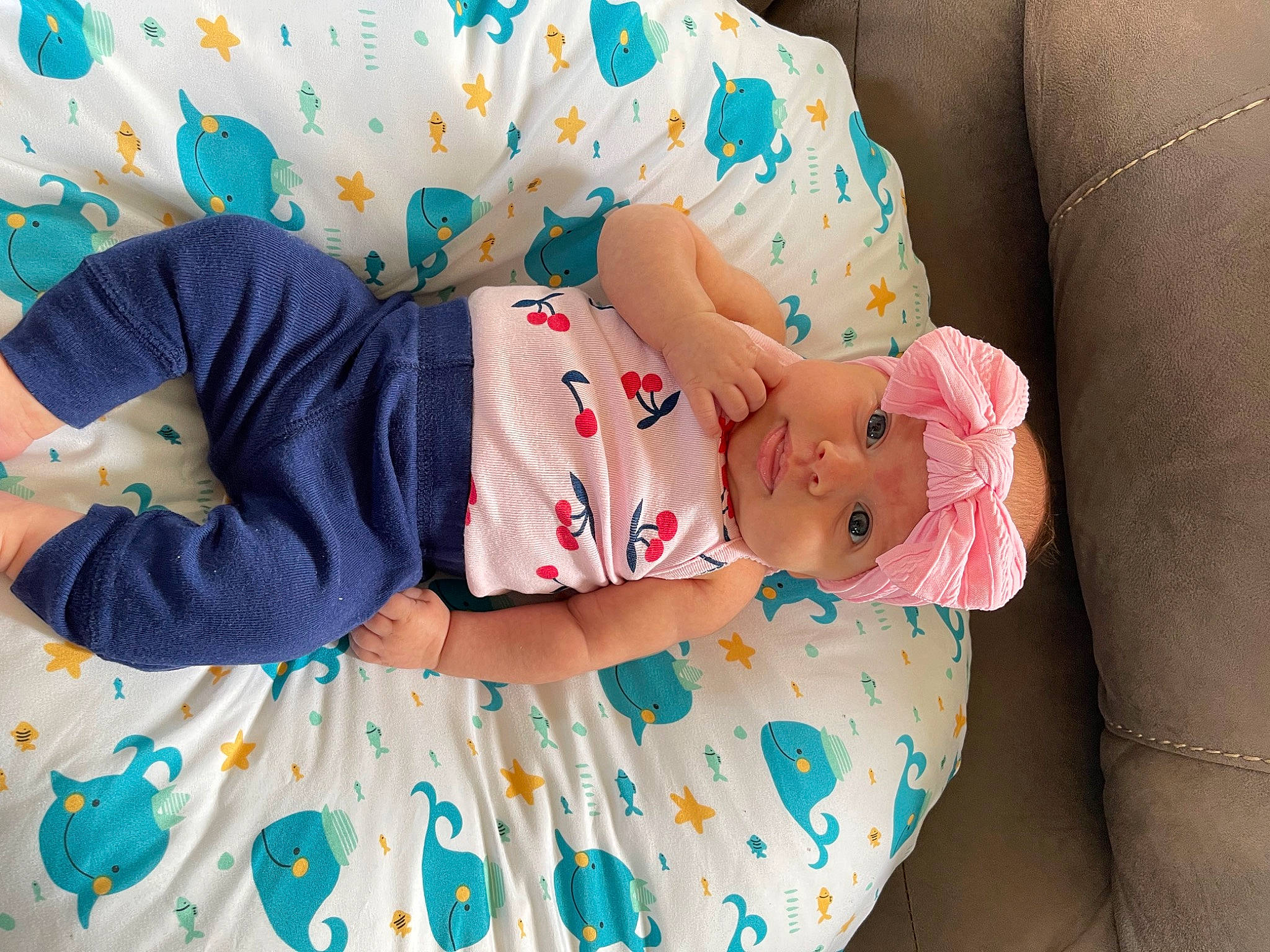 Hazel Grace is registered to the contest to win money with this photo: arm, baby, baby_products, baby_toddler_clothing, child, comfort, dress, hand, hat, head, headwear, human_body, linens, pattern, person, pink, sleeve, sock, t_shirt, textile