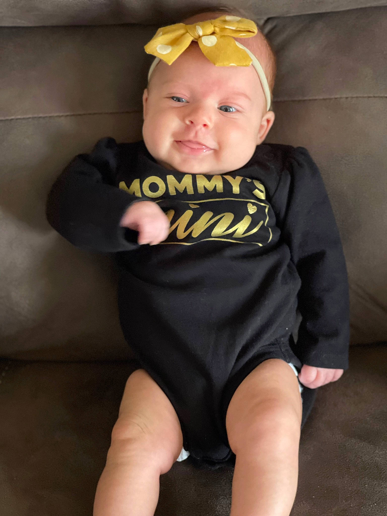 Hazel Grace is registered to the contest to win money with this photo: baby, baby_products, baby_toddler_clothing, cheek, child, eye, face, goggles, hat, headwear, human_leg, iris, knee, person, personal_protective_equipment, sitting, sleeve, smile, sunglasses, t_shirt