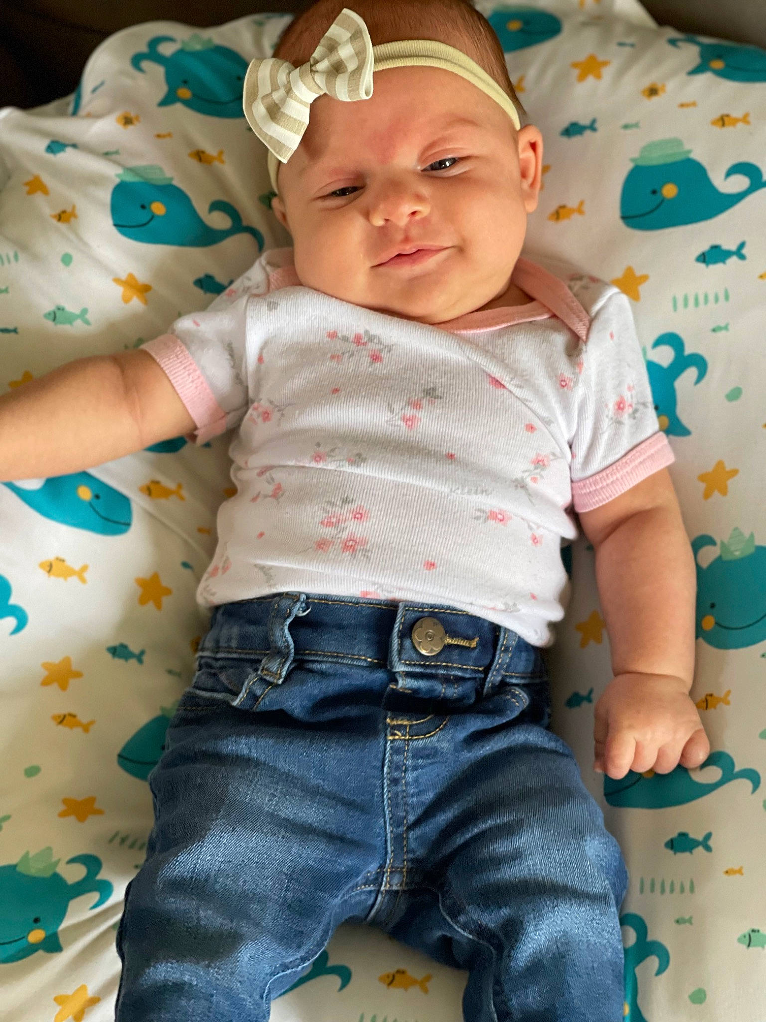 Hazel Grace is registered to the contest to win money with this photo: arm, baby, baby_toddler_clothing, cheek, chin, eye, green, happy, head, headwear, human_body, iris, jeans, leg, lip, neck, person, skin, sleeve, smile