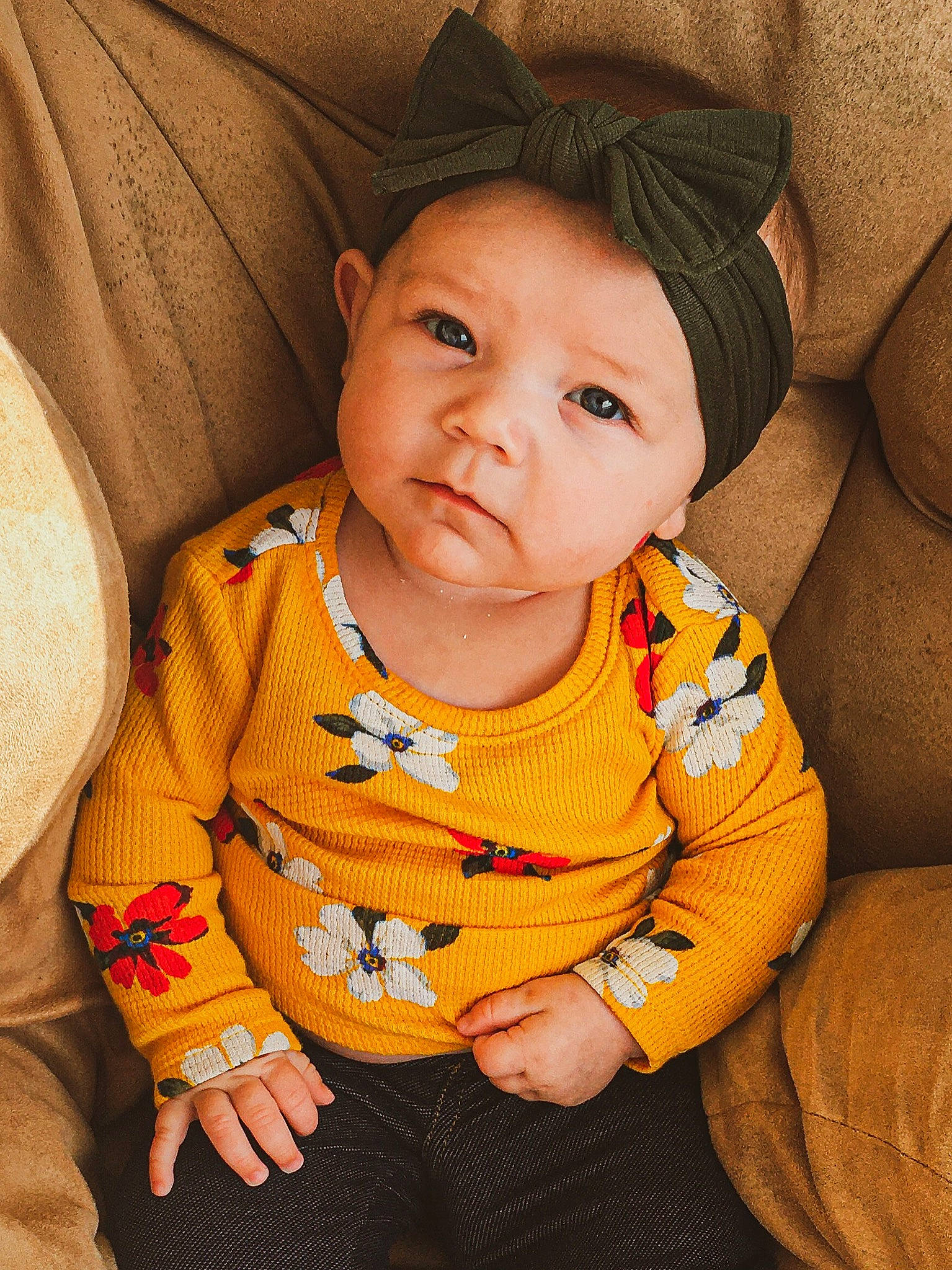 Iyanna is registered to the contest to win money with this photo: baby, baby_products, baby_toddler_clothing, cheek, child, child_model, comfort, costume_accessory, costume_hat, couch, eyelash, hair_accessory, headband, headpiece, person, pillow, sitting, slipcover, sweater, toddler