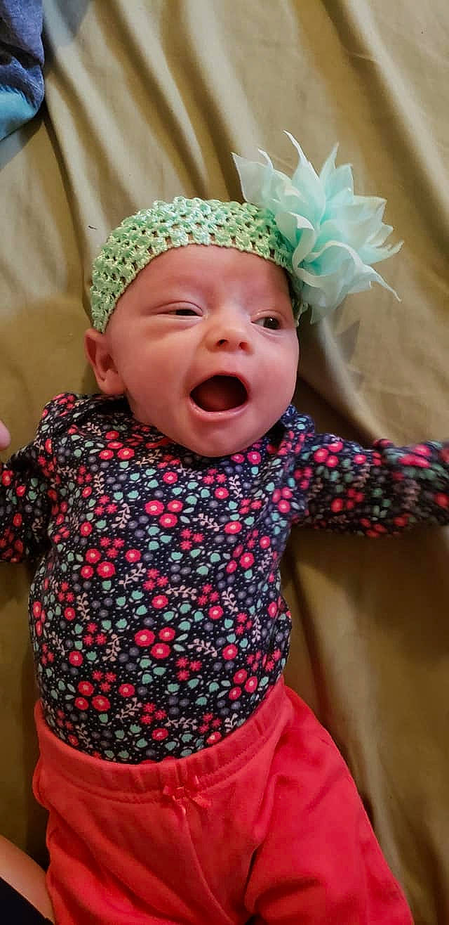 Jacelynn is registered to the contest to win money with this photo: baby, baby_laughing, baby_toddler_clothing, cheek, child, clothing, design, facial_expression, fashion_accessory, hair_accessory, happy, hat, head, headband, headgear, headwear, laugh, pattern, person, smile