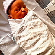 Mateo is registered to the contest to win money with this photo: newborn, baby, infant, sleeping, swaddled, hospital, blanket, cap, bed, white, peaceful, portrait, closeup, face, child, soft_light, resting, wrapped, cute, newborn_baby