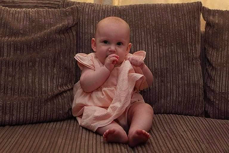 Poppy joined the competition — help win amazing prizes! baby, baby_toddler_clothing, barefoot, cheek, comfort, couch, eye, flooring, foot, gesture, hardwood, head, human_body, iris, lip, nail, person, textile, thumb, toddler