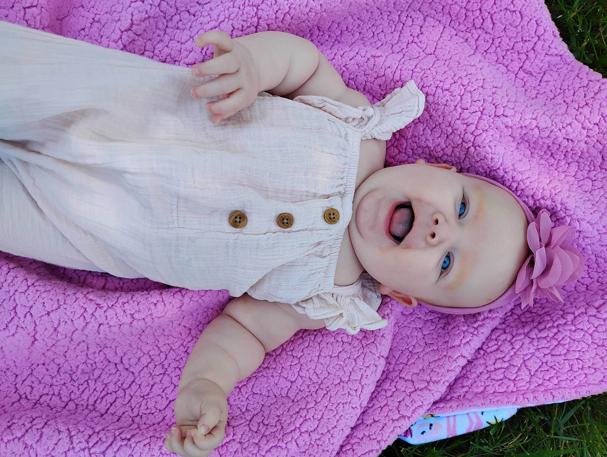 Adaleigh is registered to the contest to win money with this photo: baby, baby_toddler_clothing, cheek, child, comfort, eyelash, gesture, grass, head, headgear, human_body, iris, lip, magenta, person, pink, purple, skin, sleeve, toddler