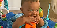 Liam joined the competition — help win amazing prizes! activity_center, baby, blue, carpet, chewing, child, colorful, curious, cute, face, hands, indoor, infant, orange_star, plastic, play, seat, smile, toy, young