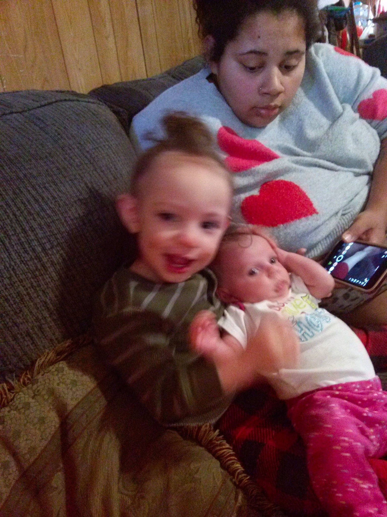 Eliana is registered to the contest to win money with this photo: baby, cheek, child, comfort, couch, event, eye, fun, happy, iris, joy, lap, living_room, mouth, person, room, sharing, sitting, skin, smile