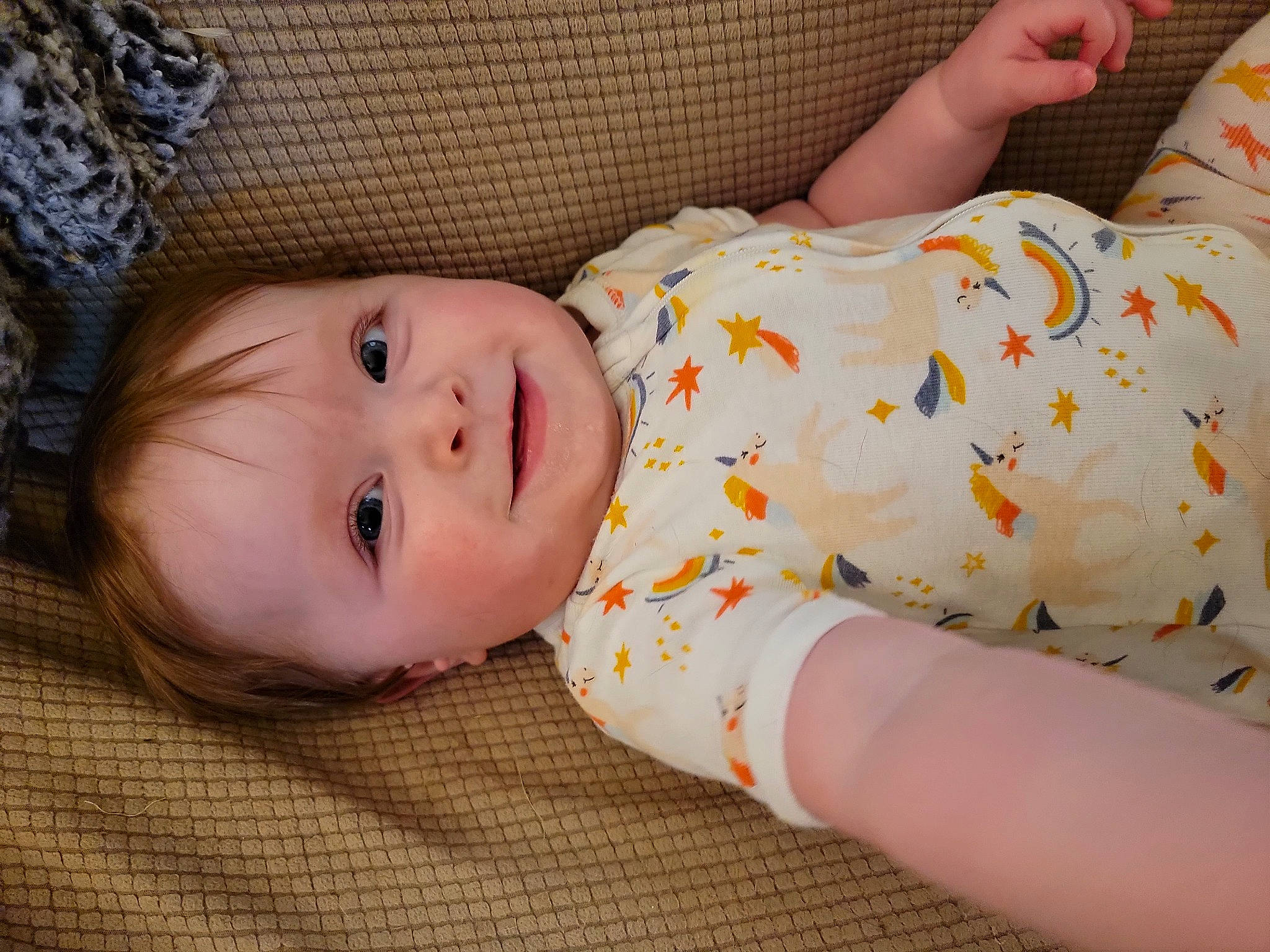 Evelyn Grace is registered to the contest to win money with this photo: arm, baby, baby_toddler_clothing, cheek, comfort, eye, facial_expression, finger, grass, hand, head, joy, lip, mammal, nose, pattern, person, skin, sleeve, toddler