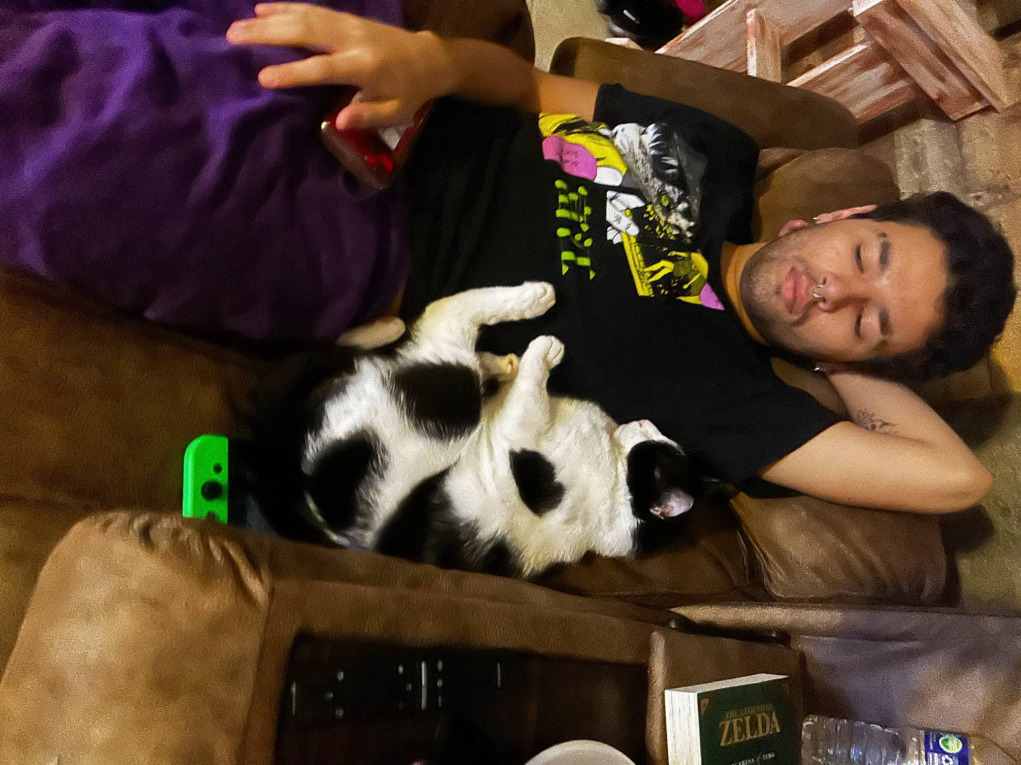Deku is registered to the contest to win money with this photo: arm, carnivore, cat, comfort, companion_dog, couch, felidae, fun, fur, gamer, happy, lap, nail, remote_control, room, sitting, small_to_medium_sized_cats, t_shirt, thigh, wrist
