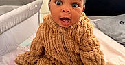 Giovanna joined the competition — help win amazing prizes! baby, baby_wipes, bed, blanket, child, clothing, crib, cute, fuzzy_outfit, hair_ties, headboard, indoor, infant, nursery, person, portrait, seated, soft_texture, surprised_expression, wide_eyes