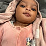 baby, infant, blanket, pink_clothing, minnie_mouse, onesie, cute, child, portrait, soft_texture, sleepwear, adorable, lying_down, toddler, face, young_child, cozy, fabric, earrings, closeup