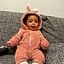 Giovanna is registered to the contest to win money with this photo: baby, child, infant, onesie, bunny_ears, pink_clothing, couch, sofa, gray_fabric, sitting, cute, smiling, indoors, cozy, soft_texture, white_socks, portrait, happy, face, young_child