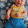 baby, smiling, infant, yellow_tank_top, blue_shorts, owl_pattern, blanket, milestone_card, 3_months, happy, cute, child, lying_down, portrait, indoor, soft_texture, baby_clothes, hand, foot, face