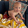 Jaxsin is registered to the contest to win money with this photo: baby, bare_chest, blue, child, clothing, couch, face, furniture, geometric, happy, home, indoor, pattern, person, pillow, playful, smile, toddler, towel, yellow