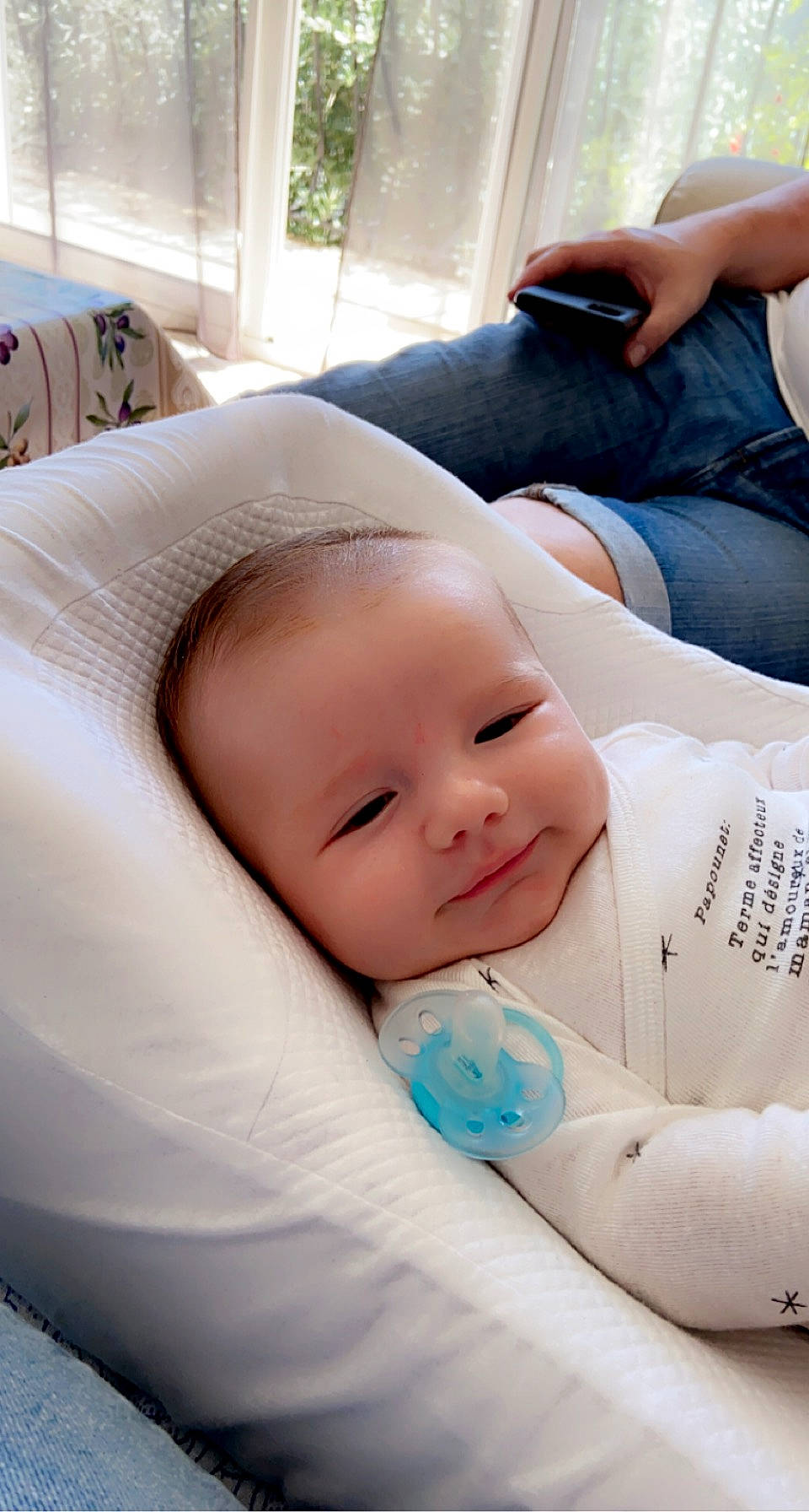 Marin participe au concours pour gagner de l'argent avec cette photo : baby, baby_toddler_clothing, camera, cheek, child, comfort, happy, linens, mobile_phone, person, portable_communications_device, portrait_photography, room, sitting, skin, sleeve, smile, textile, toddler