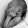 baby, newborn, sleeping, black_and_white, blanket, infant, peaceful, cute, portrait, soft_texture, skin, hand, face, head, ear, resting, closeup, cozy, tender, child