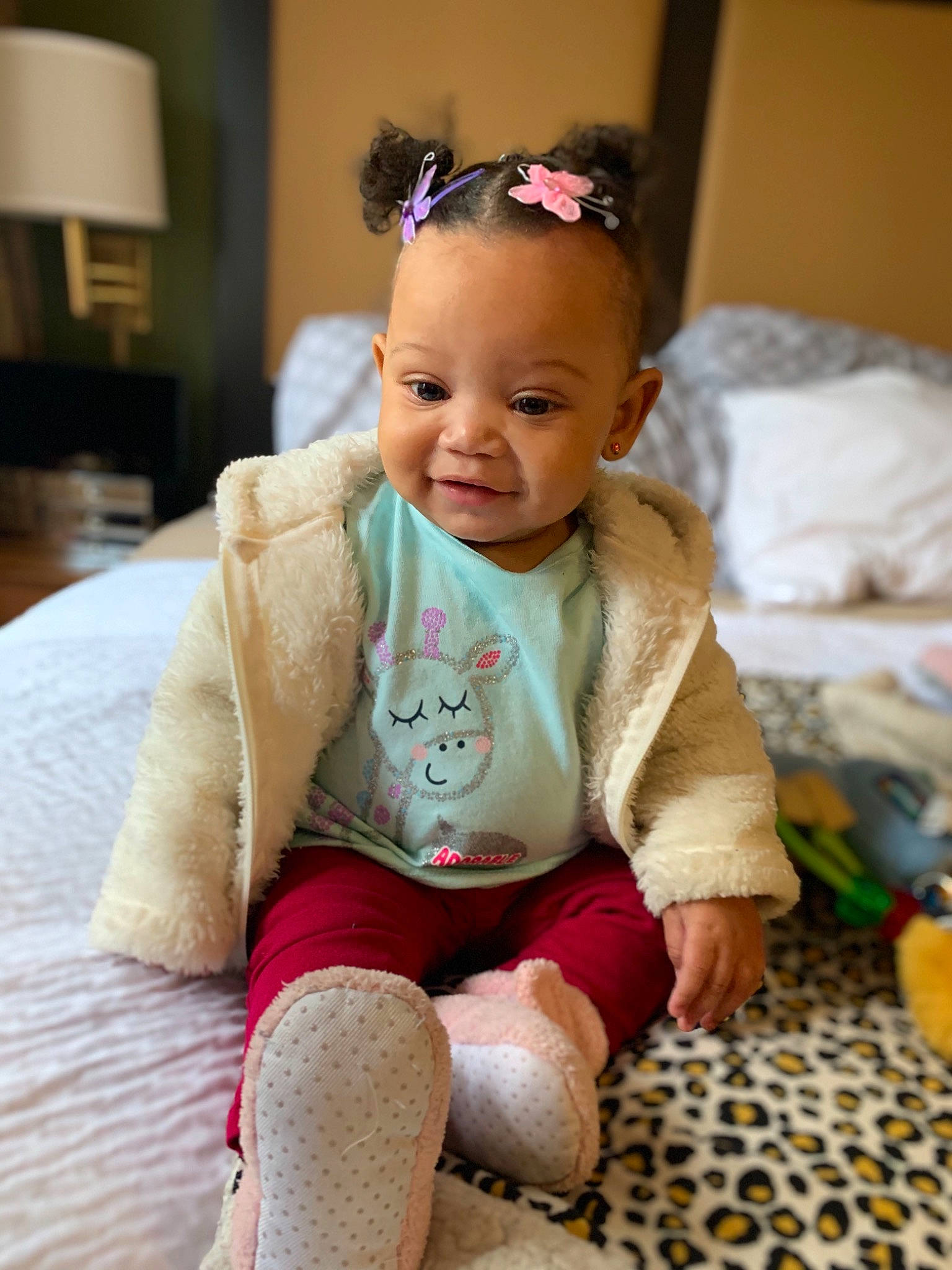 Khloee is registered to the contest to win money with this photo: baby, beauty, cheek, child, ear, eye, face, head, iris, joy, people, person, pink, room, sitting, skin, smile, toddler, vacation