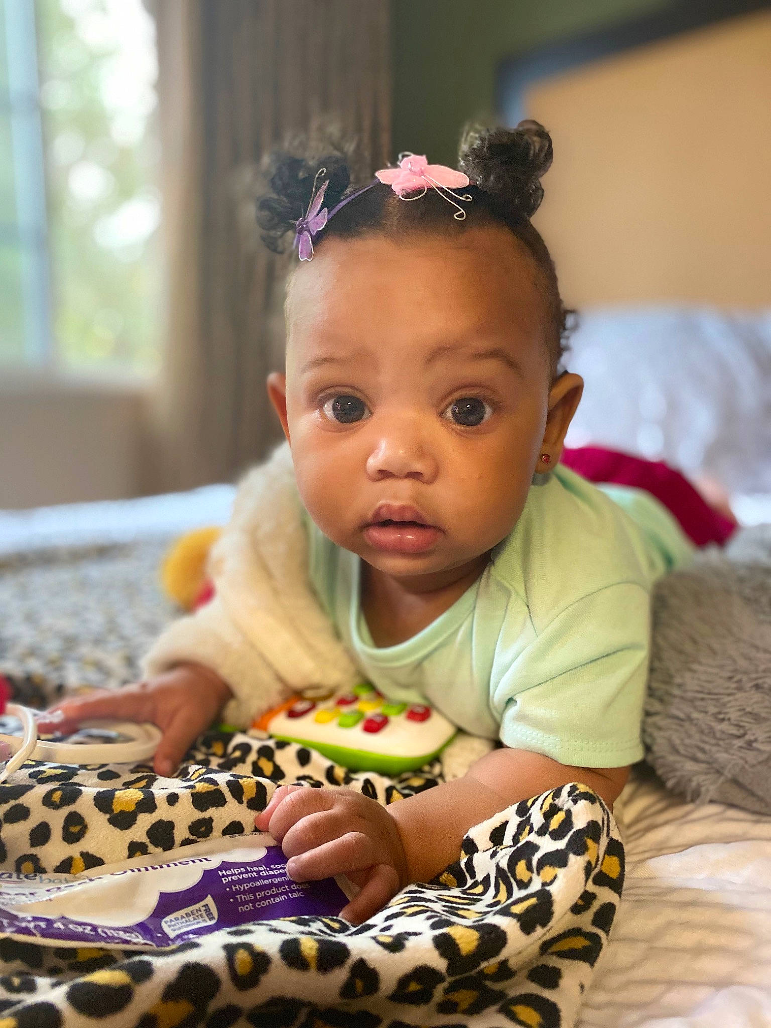 Khloee joined the competition — help win amazing prizes! baby, baby_products, baby_toddler_clothing, beauty, cheek, child, ear, eye, face, hair_accessory, head, headband, pattern, person, play, product, sitting, skin, toddler, tummy_time