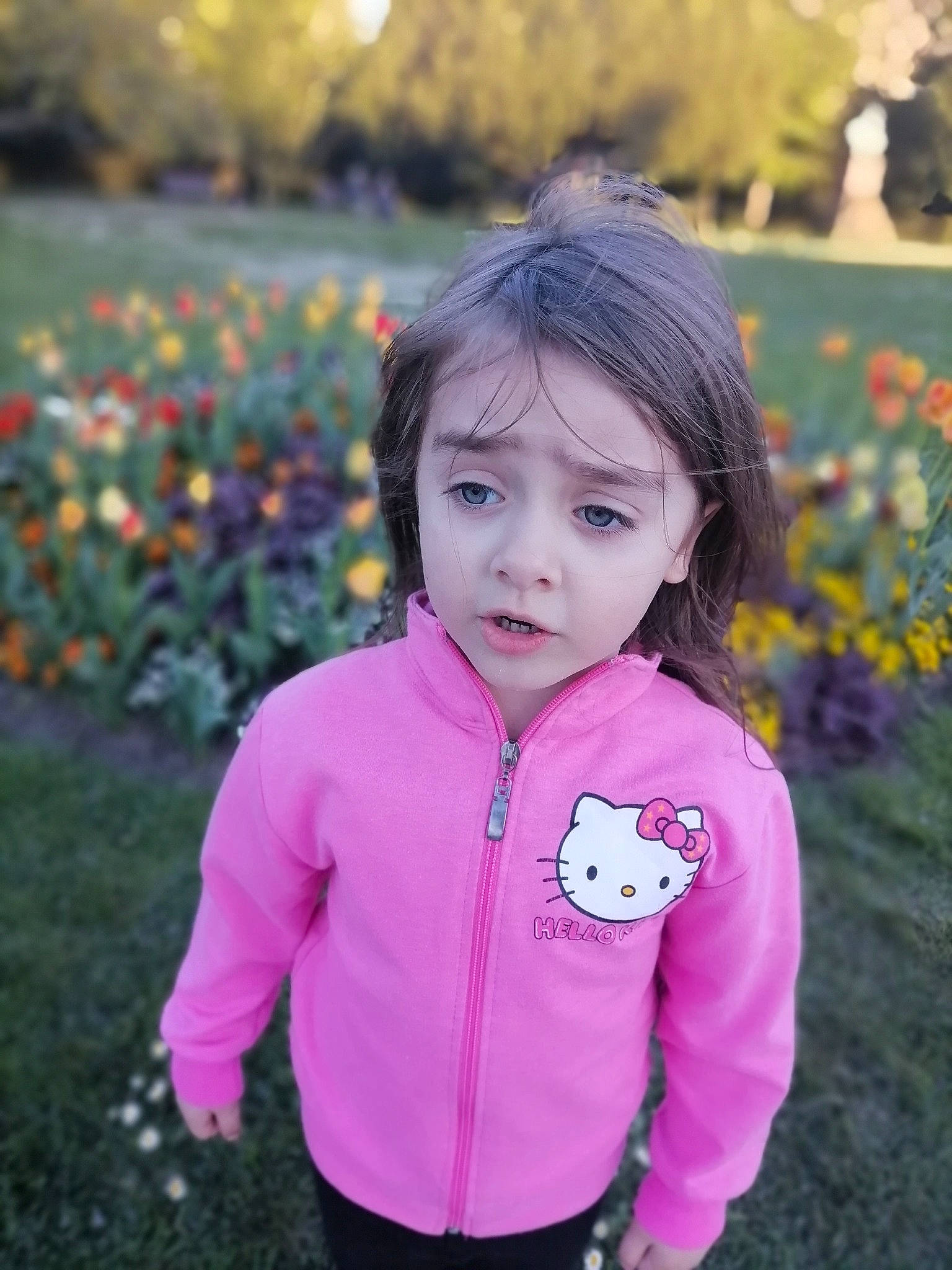 Erika participe au concours pour gagner de l'argent avec cette photo : baby_toddler_clothing, beauty, black_hair, botany, child, flower, grass, happy, iris, leaf, magenta, people_in_nature, person, petal, pink, plant, purple, sleeve, toddler, tree