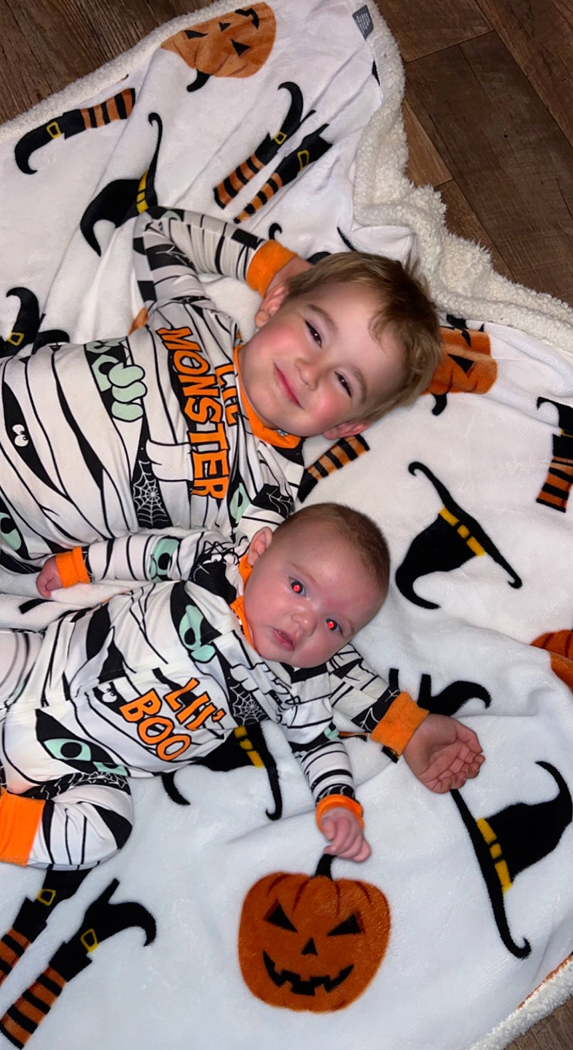 Xander is registered to the contest to win money with this photo: art, baby, black, calabaza, child, happy, joy, mammal, orange, outerwear, pattern, person, photograph, product, pumpkin, sleeve, smile, t_shirt, textile, toddler