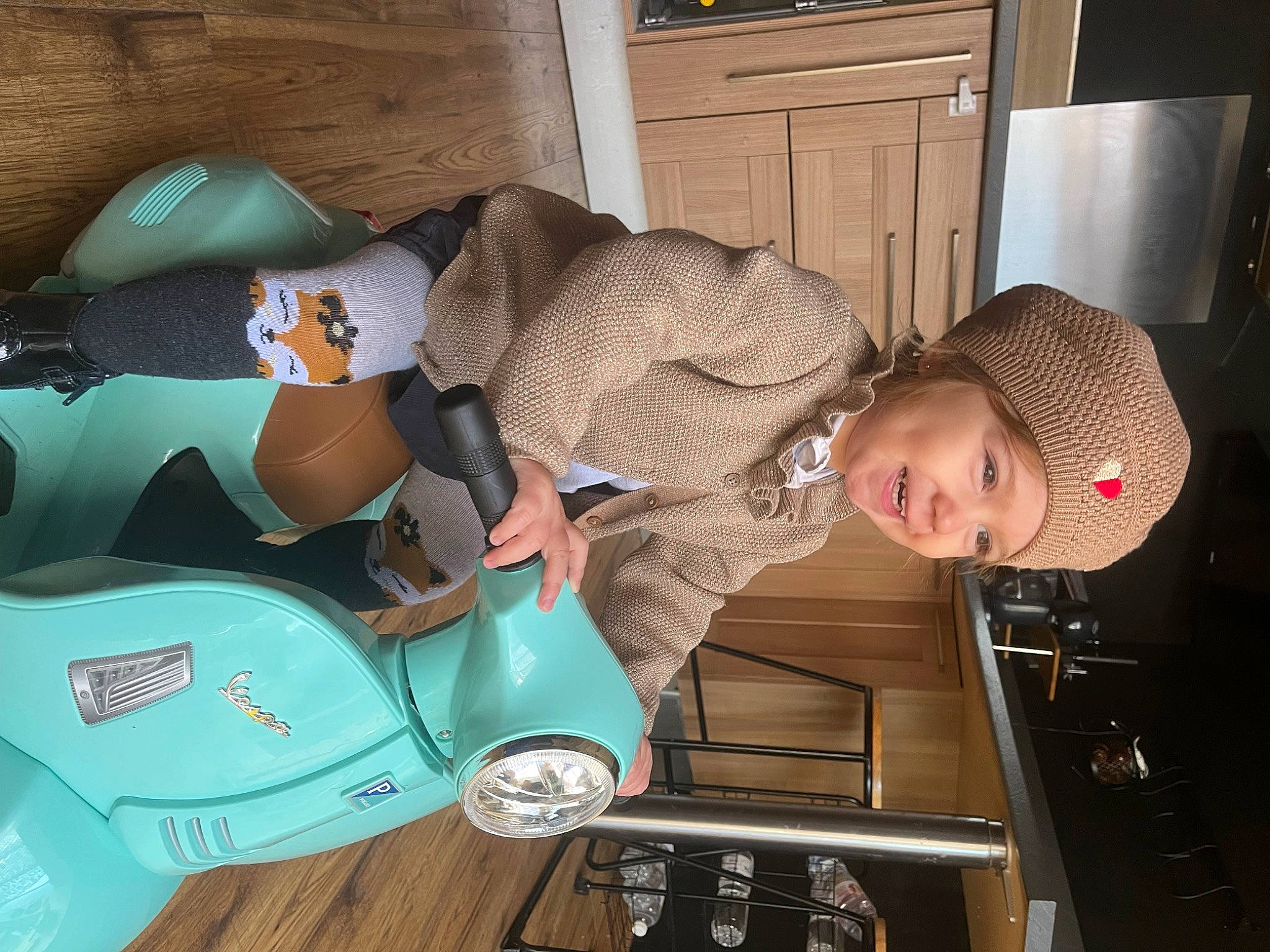 Jade participe au concours pour gagner de l'argent avec cette photo : baby, baby_products, cabinetry, child, comfort, flooring, fun, hat, headwear, human_body, person, plastic, riding_toy, room, sitting, tire, toddler, wheel, wood