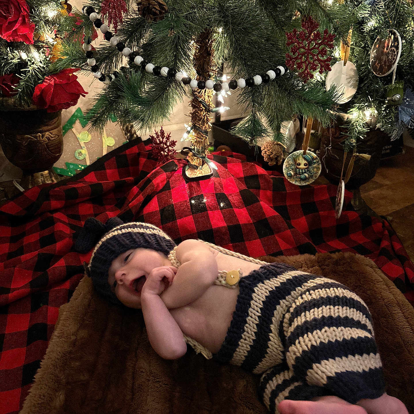 Tyrus joined the competition — help win amazing prizes! baby, blanket, christmas_tree, cute, decorations, festive, groot_ornament, hat, holiday, indoor, infant, knit_clothing, lights, ornaments, pine_cones, plaid, red_rose, smiling, striped_pants, toddler