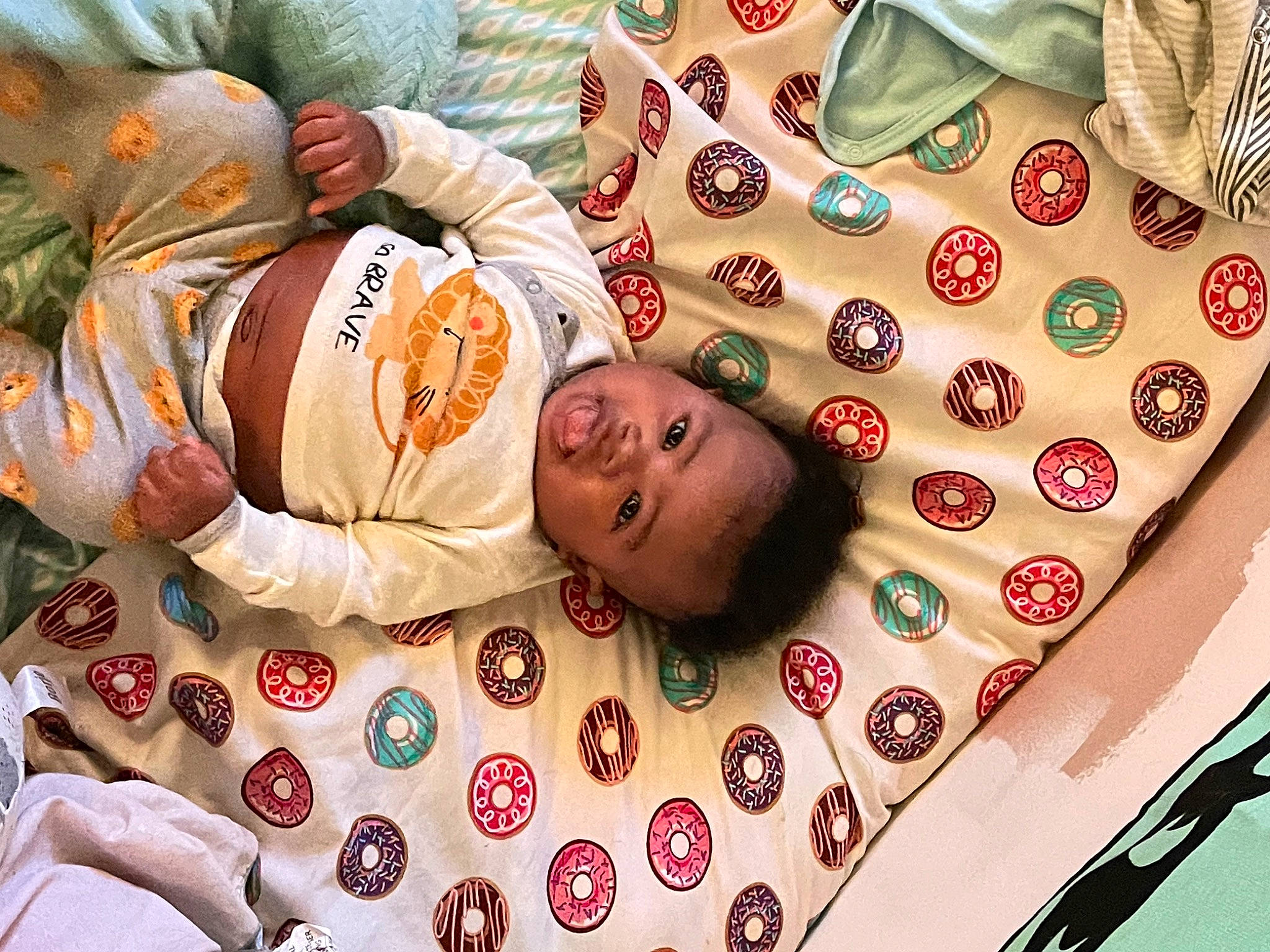 Hezekiah joined the competition — help win amazing prizes! arm, baby, baby_sleeping, baby_toddler_clothing, cheek, child, comfort, eye, face, facial_expression, happy, head, human_body, linens, mouth, orange, pattern, person, red, skin