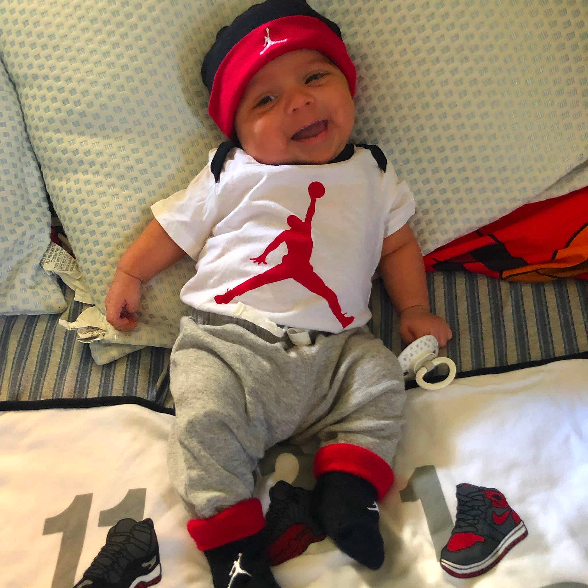 Luciano is registered to the contest to win money with this photo: baby, baby_toddler_clothing, cap, comfort, cool, fun, happy, headwear, knee, leg, people, person, photograph, product, red, shoe, sleeve, smile, sneakers, t_shirt