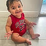 Cyphyr Pineda is registered to the contest to win money with this photo: baby, child, smiling, red_clothing, air_jordan, indoor, floor, tile_floor, happy, sitting, hand, foot, wall, door, window, person, cute, infant, young_child, casual