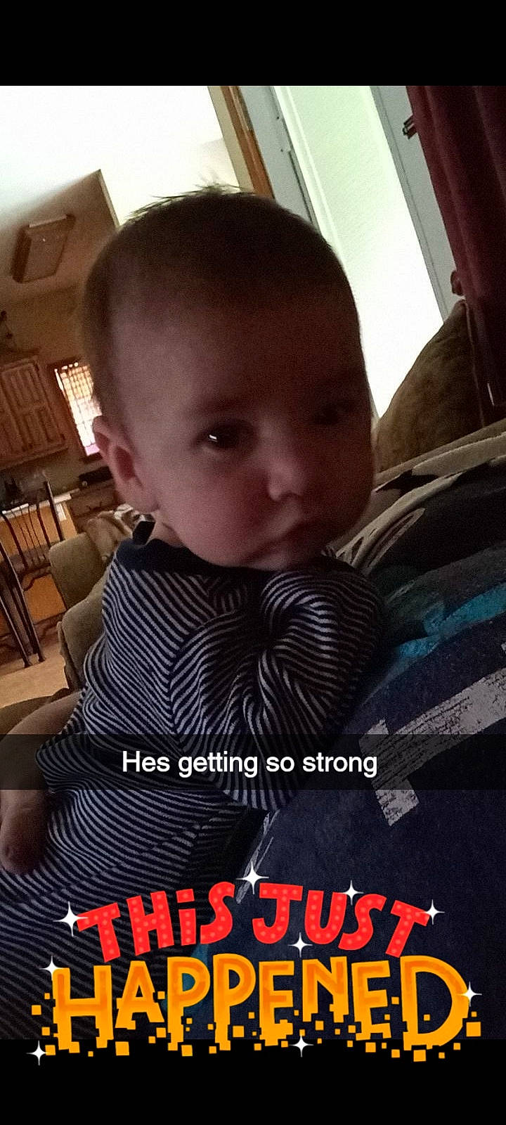 Dennver is registered to the contest to win money with this photo: baby, black_hair, cheek, child, cool, face, forehead, head, human, neck, nose, outerwear, person, photo_caption, photography, product, sleeve, smile, toddler