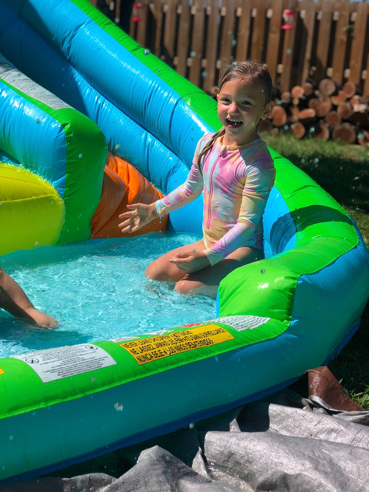 Chandler is registered to the contest to win money with this photo: amusement_park, chute, fun, games, green, inflatable, leisure, nonbuilding_structure, park, person, play, recreation, vacation, water, water_park